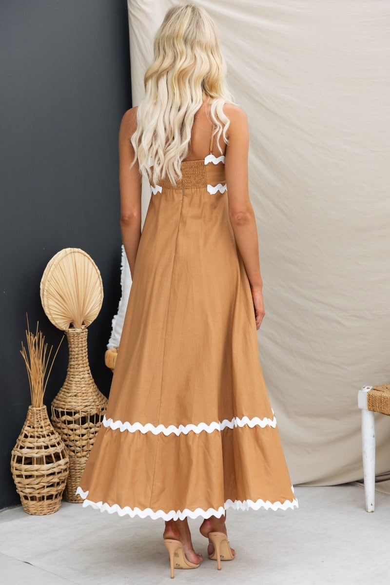 Back view of Guyara Maxi Dress featuring adjustable straps, elastic back, and playful trim, styled in a tan color.