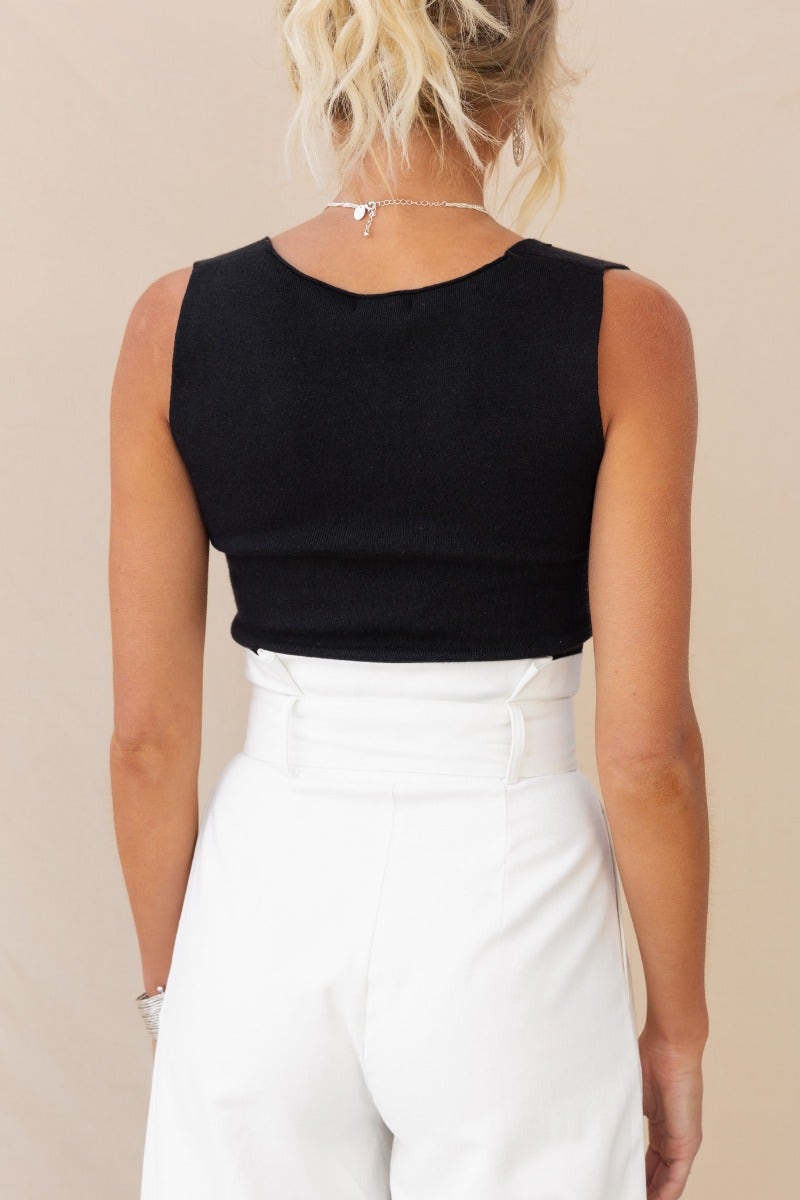 Back view of the Carrie Top in black ribbed knit, featuring a square neckline and cropped fit, perfect for stylish layering.