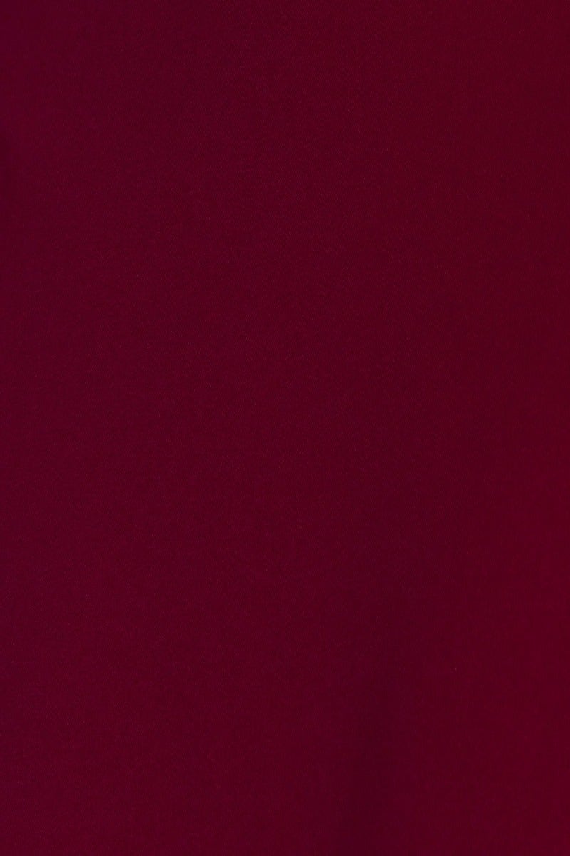 Close-up of soft burgundy fabric showcasing the texture, perfect for the Broadway Midi Dress.