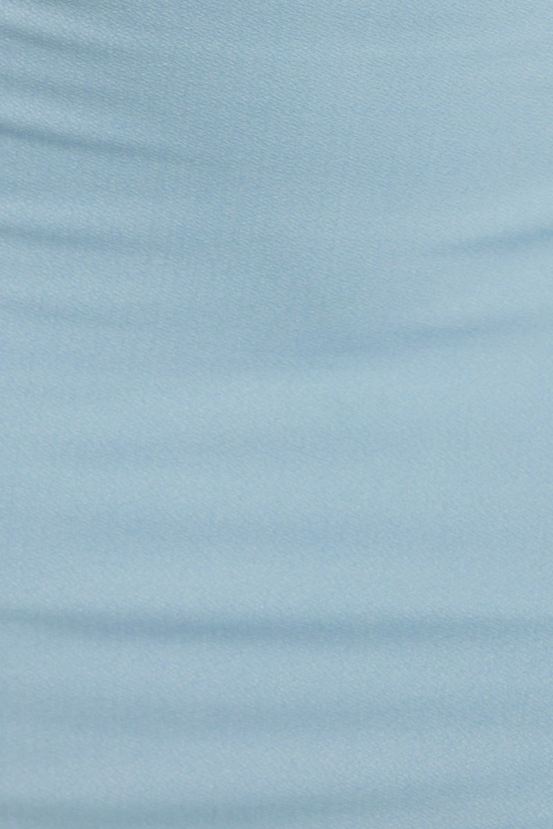 Close-up of the smooth light blue fabric of a bodycon midi dress, showcasing its stretchy texture.