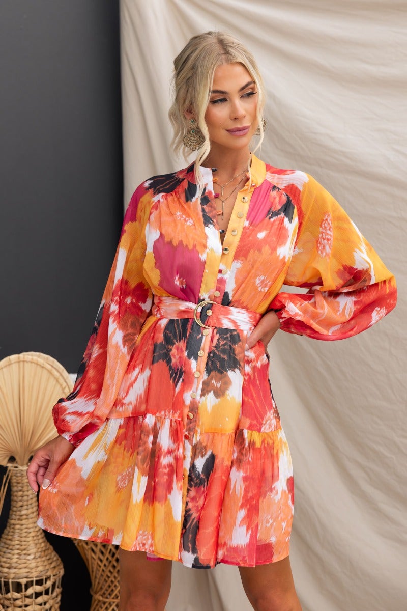Model wearing Orazio Dress, a multi-colour chiffon dress with a high neckline and button-up front.