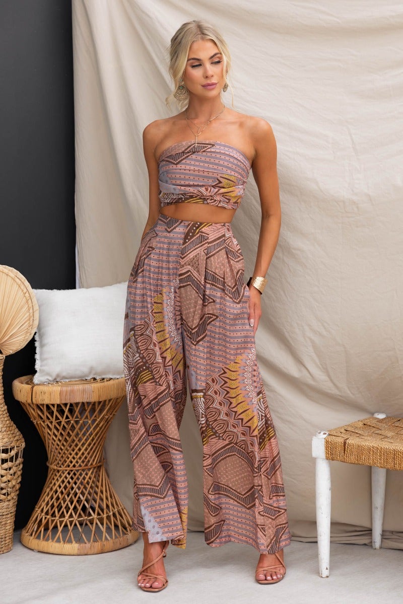 Model wearing Halia Pants with abstract print, mid-high waist fit, styled with a matching top.