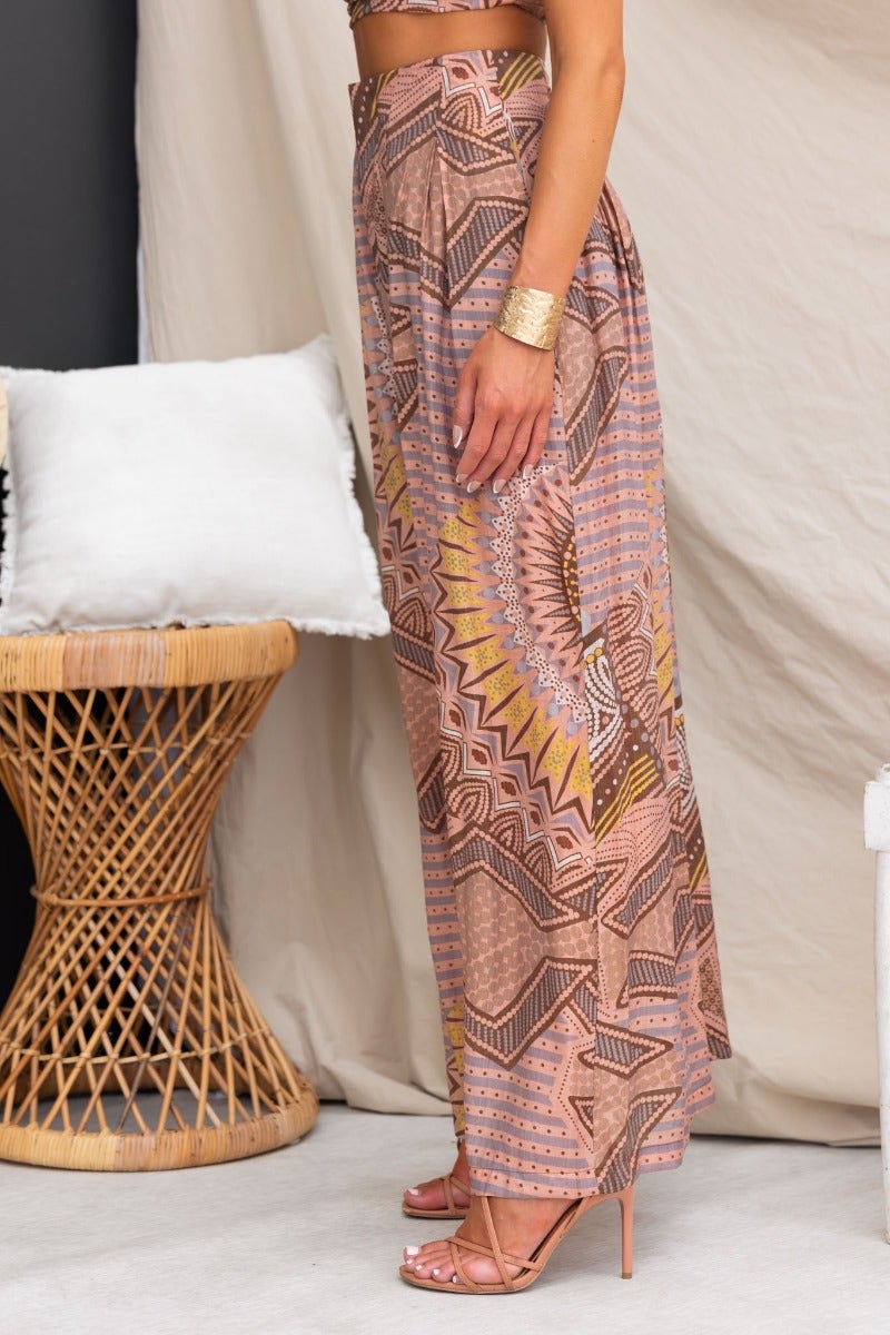 Halia Pants featuring abstract print, mid-high waist fit, light material, lined, styled with strappy heels.