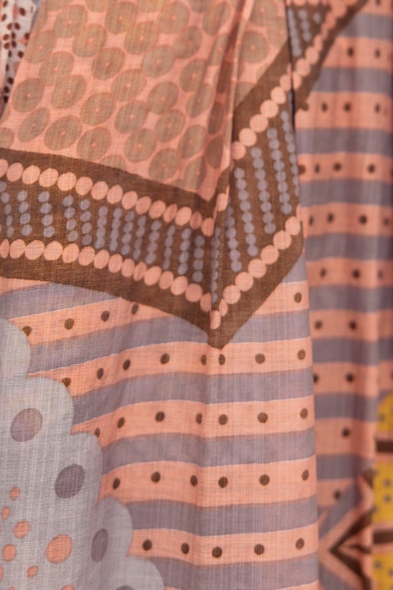 Close-up of Halia Pants showcasing abstract print patterns in blush tones and intricate detailing.