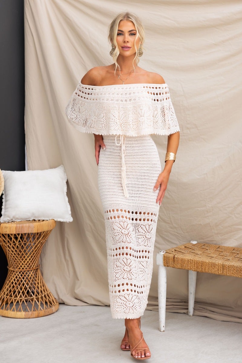 Elva Maxi Dress featuring an off-shoulder neckline, drawstring waist, and crochet material in a stylish design.