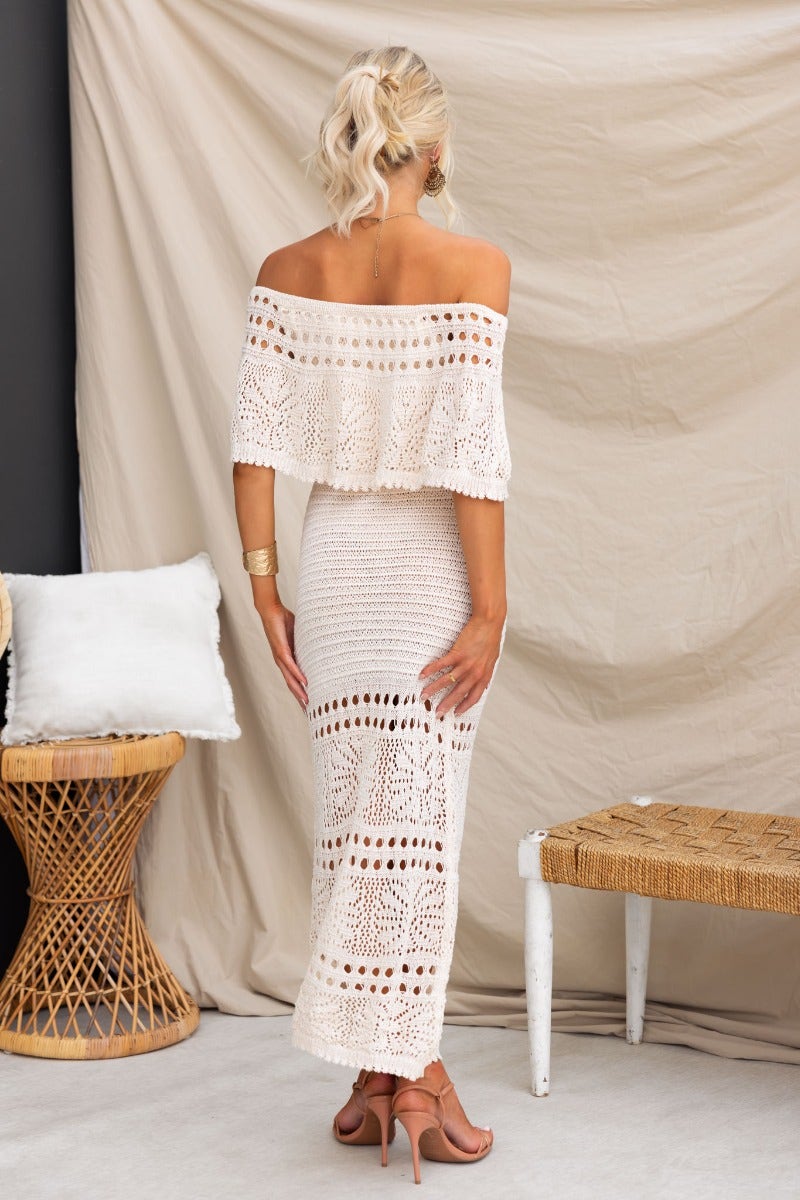 Back view of Elva Maxi Dress in crochet material with elastic off-shoulder neckline, showcasing stylish open weave design.