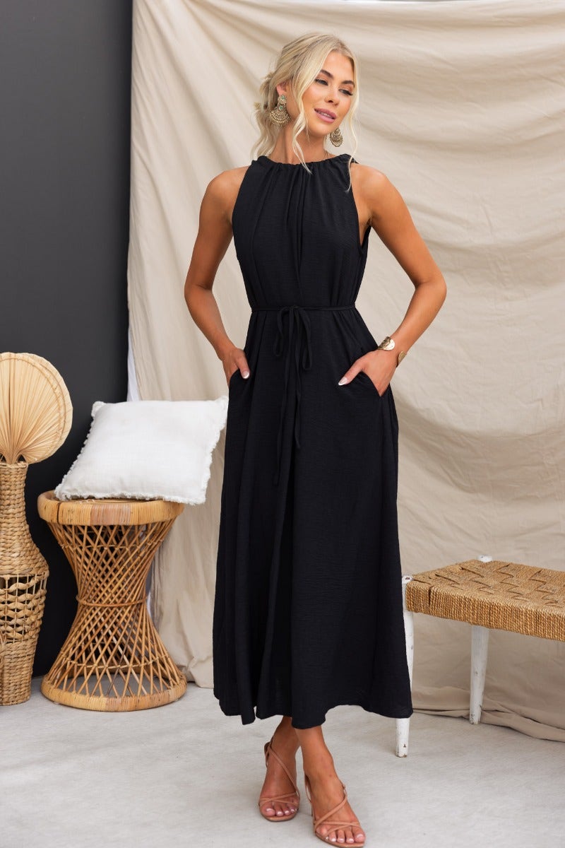 Model wearing Iwaki Black Maxi Dress with adjustable neckline and pockets, showcasing an oversized fit.
