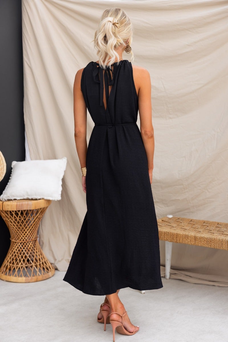 Back view of black Iwaki Maxi Dress featuring adjustable drawstring neckline and textured material.