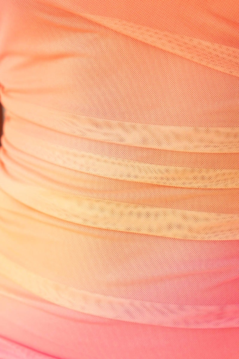 Close-up of the mesh overlay fabric in a gradient from pink to orange, showcasing texture and design detail.