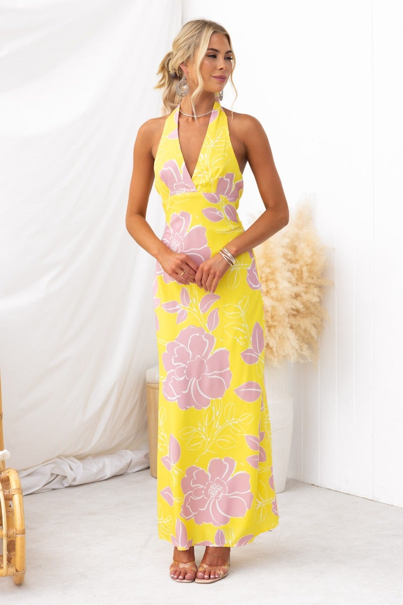 Chirpy Maxi Dress with floral print, adjustable halter neckline, non-slip back, and lightweight design, modeled by a woman.
