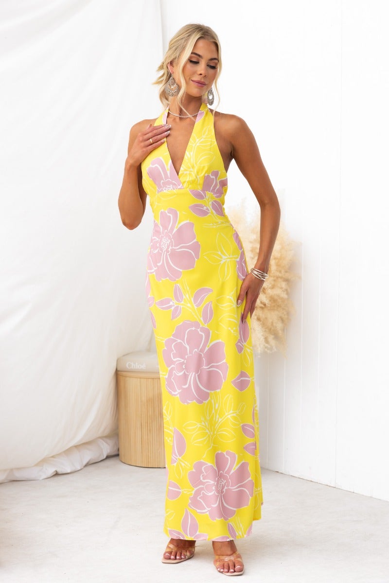 Chirpy Maxi Dress in yellow floral print with adjustable halter neckline, ideal for summer occasions.