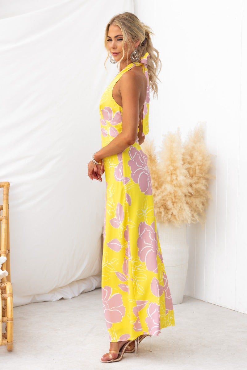 Chirpy Maxi Dress in yellow floral print, featuring adjustable halter neckline and flowing silhouette.