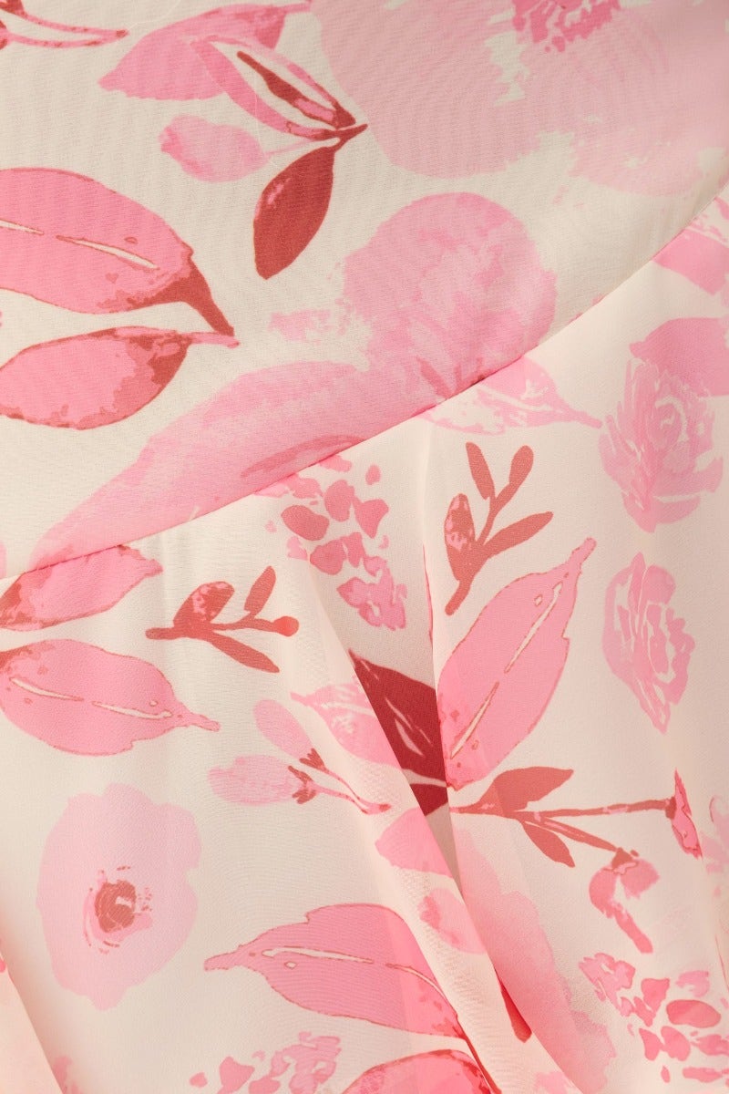 Close-up of pink floral print on chiffon fabric of the Klaudia Maxi Dress, featuring delicate leaves and blossoms.
