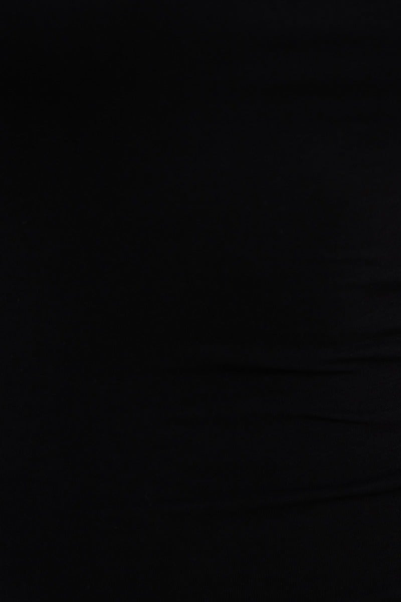 Close-up of the black cotton jersey fabric of the Dion Midi Dress, showcasing its soft texture and stretch.