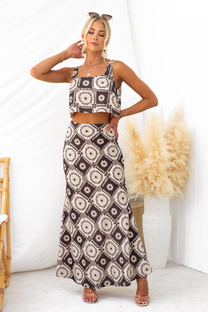 Model wearing Theda Top with floral print, paired with a matching skirt, showcasing a square neckline and stylish crop fit.