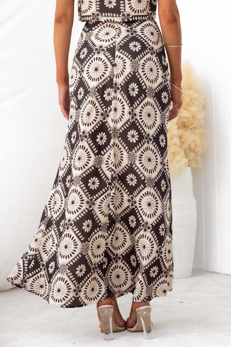 Back view of Theda maxi skirt featuring a floral print design and elegant flowing fabric.