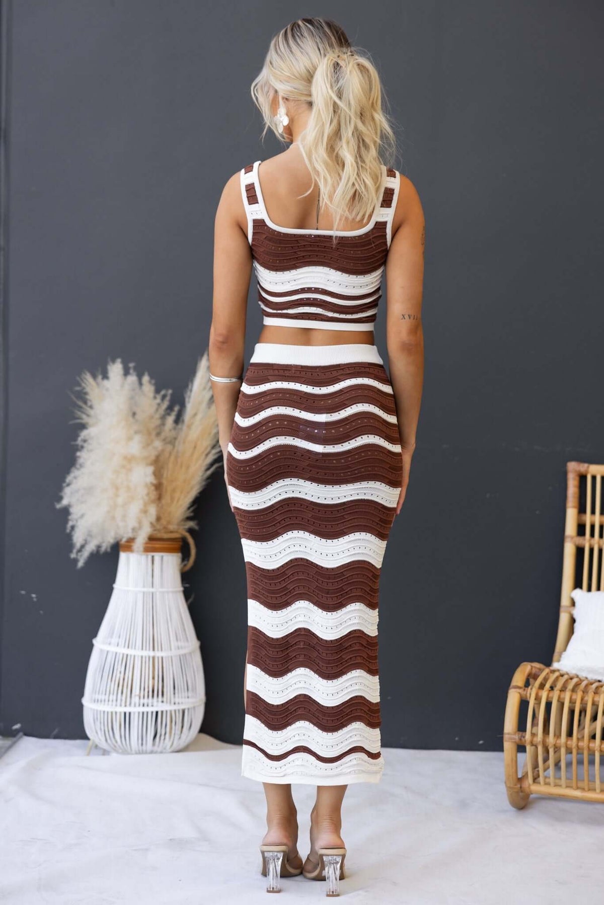 Model showcasing the Lafina Set, featuring a knit crop top and midi skirt with a stylish wavy pattern.
