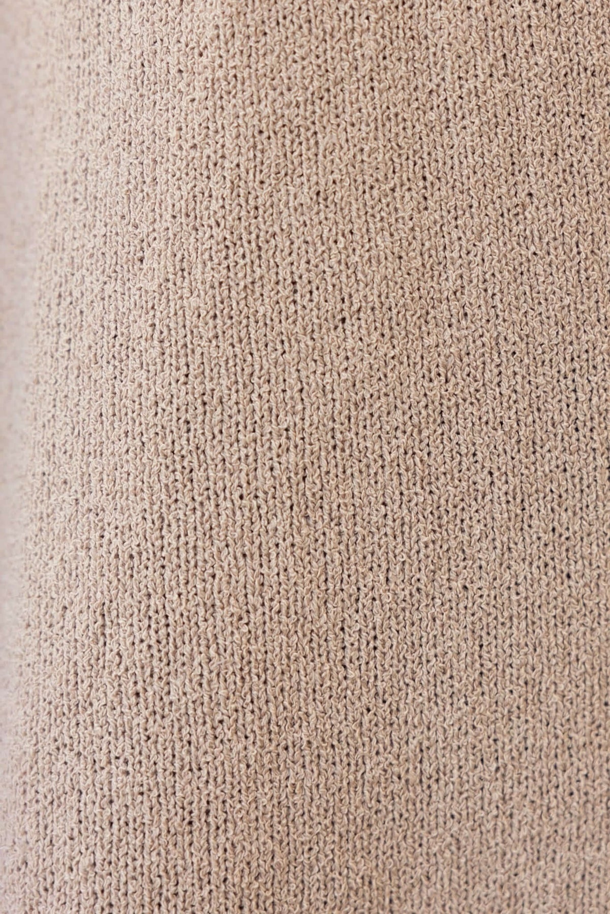 Close-up of knit fabric texture in beige, showcasing stretch and soft material quality for the Indiana Dress.