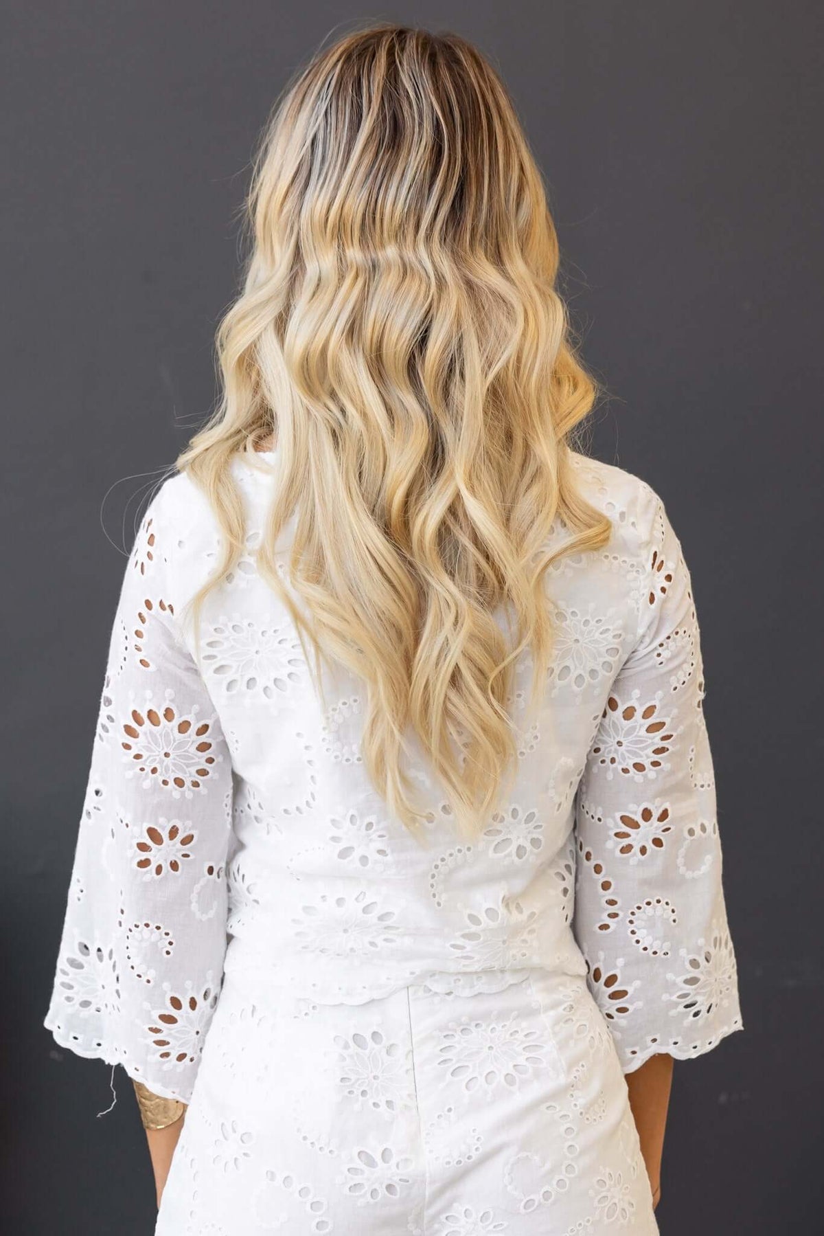 Back view of a woman wearing the Georgie Set featuring a boat neckline and Anglaise material.