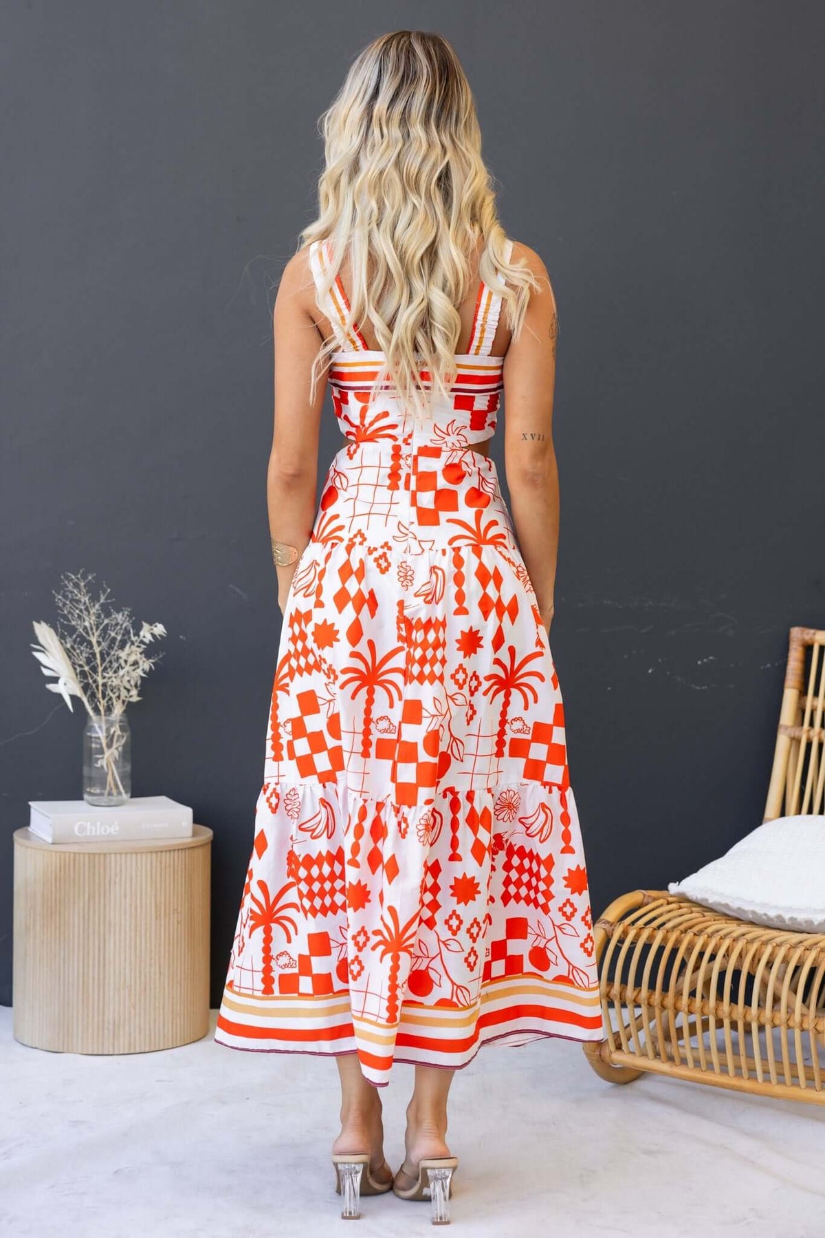 Back view of the Arrte Maxi Dress featuring vibrant patterns and an elastic strap design.