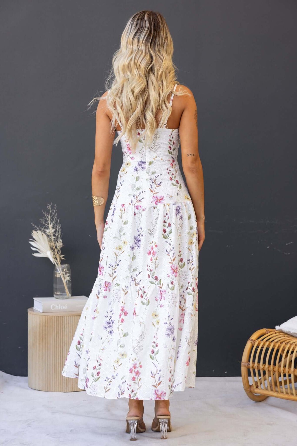 Back view of Carlyle Maxi Dress featuring floral print, adjustable straps, and flowing silhouette.