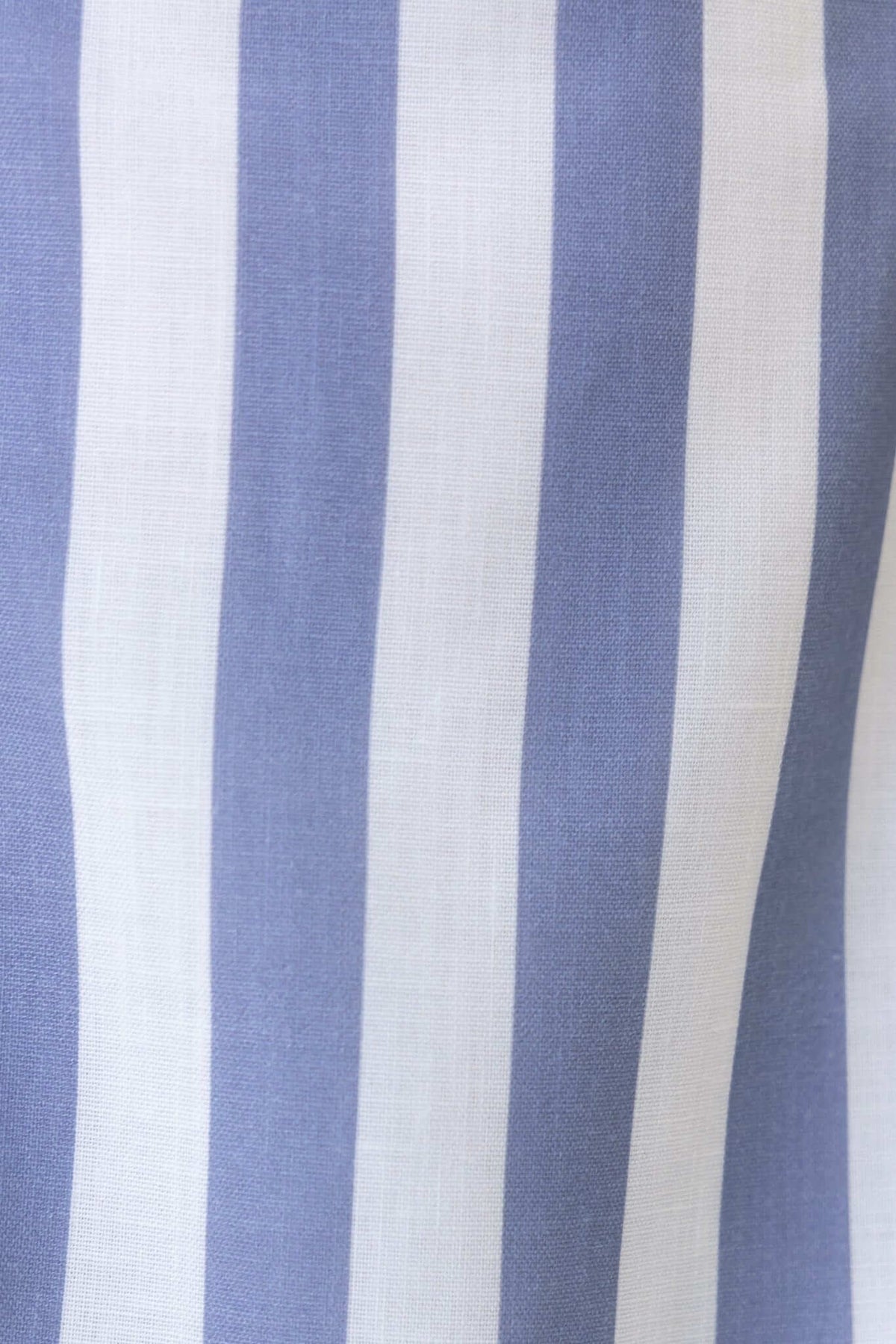 Close-up of light blue and white striped fabric, showcasing a smooth texture suitable for casual wear or dresses.