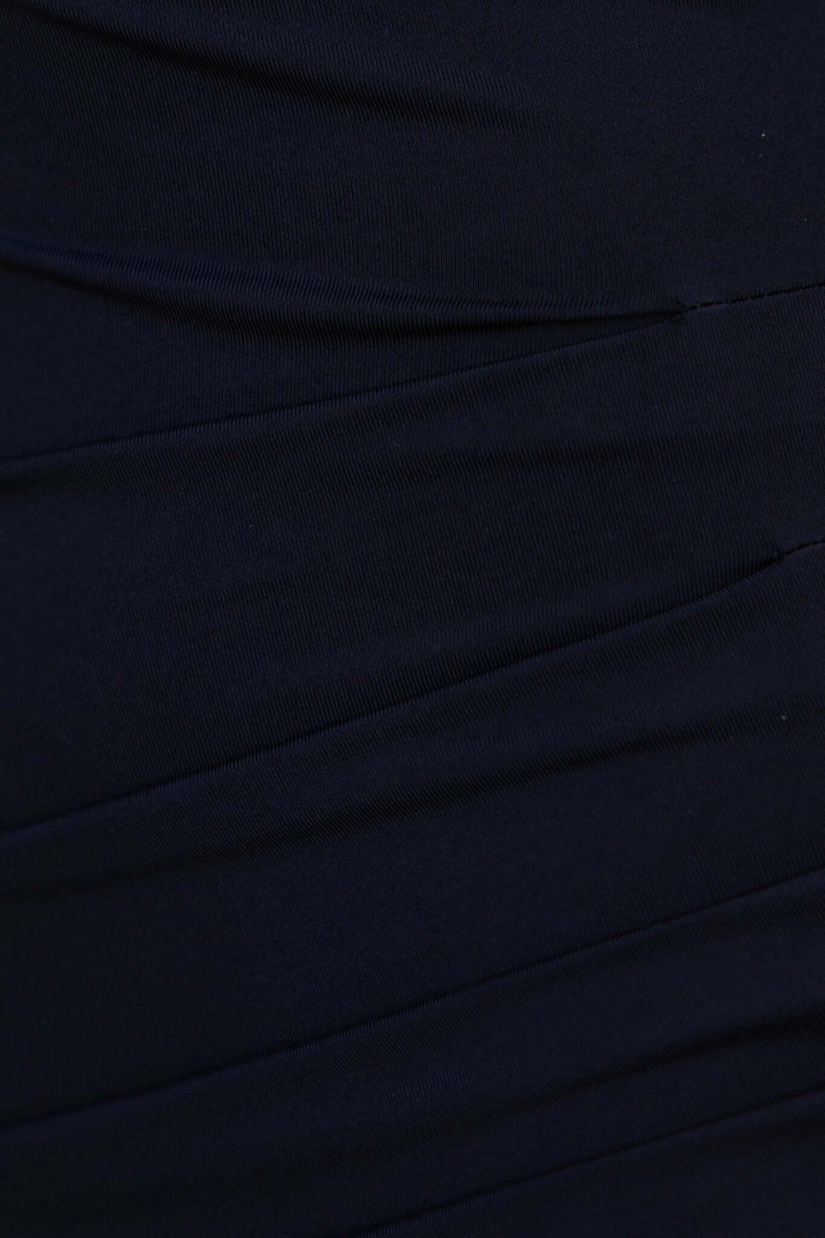 Close-up of textured black fabric of the Dien Dress featuring subtle ruching and stretch material.