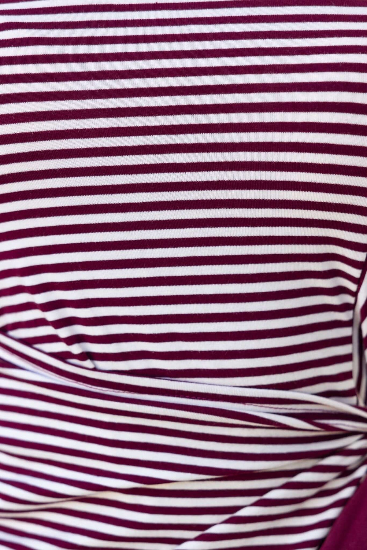 Close-up of Gozoa Dress featuring burgundy and white striped fabric with a wrap tie detail.