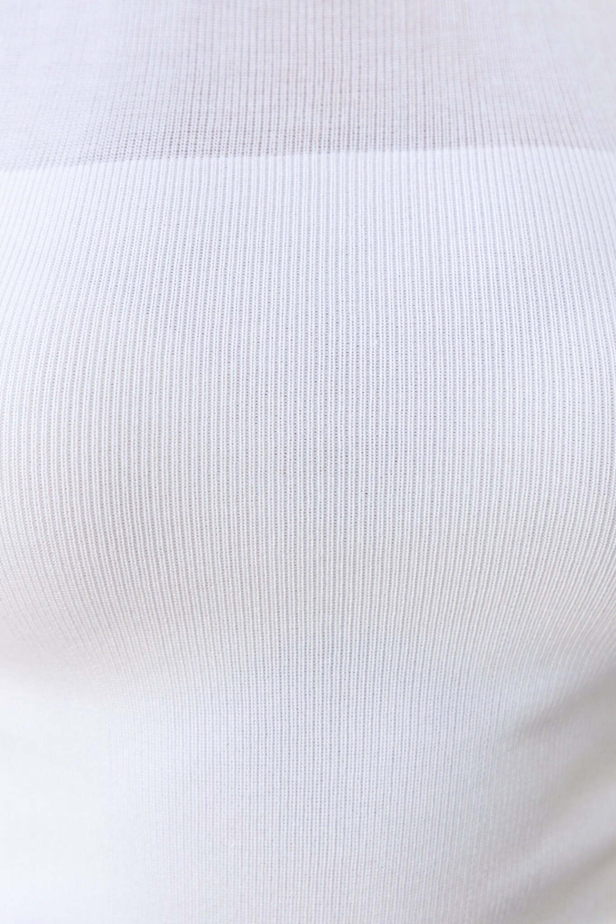 Close-up of the sheer panel at the chest of the Topaz Tee, showcasing its knit ribbed material and texture.