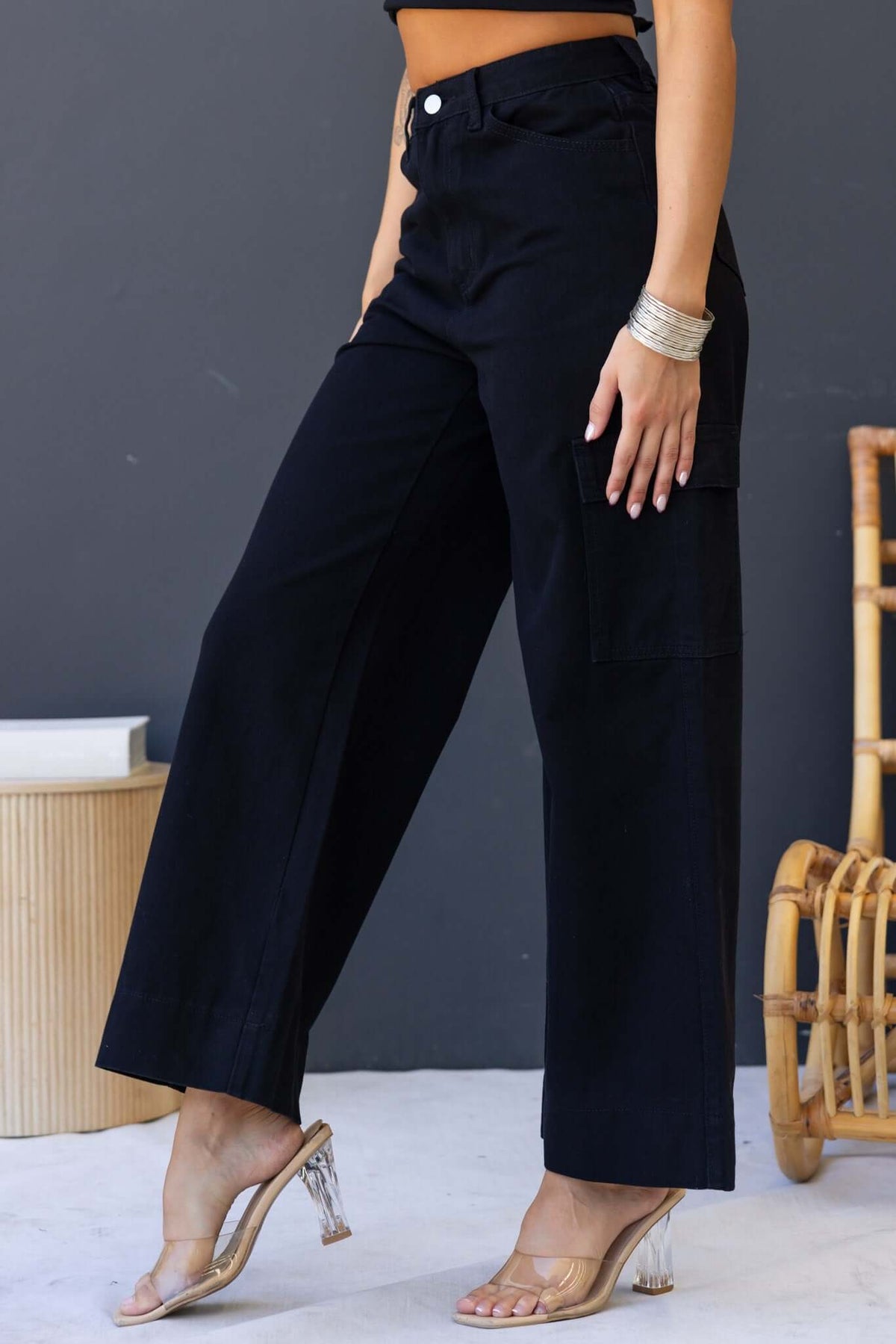 Chandler Jeans in black, wide cargo style with mid-high waist and multiple pockets, worn with stylish footwear.