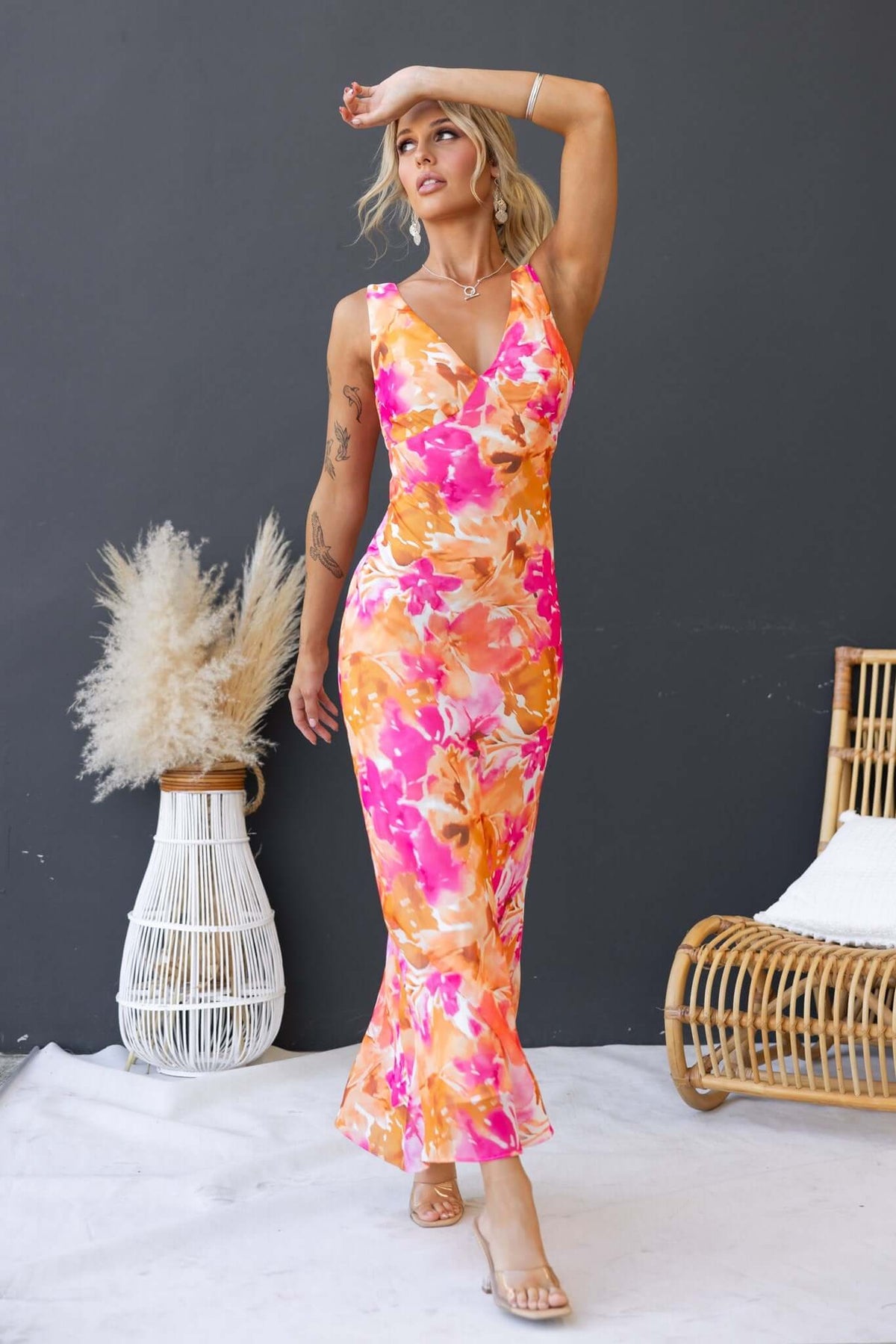 Model wearing Qilax Maxi Dress with V-neckline and floral pattern, showcasing a stylish and elegant summer look.
