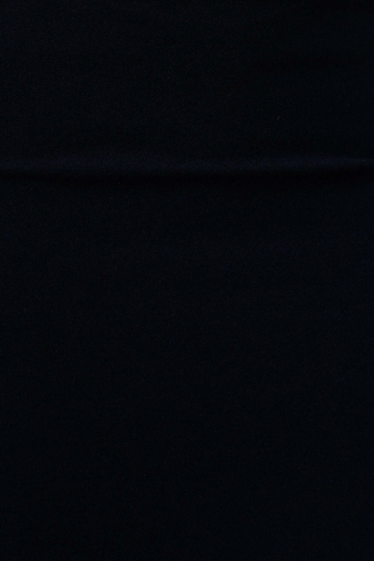 Close-up view of the smooth black fabric texture of the Lillette Midi Dress, showcasing its soft polyester material.