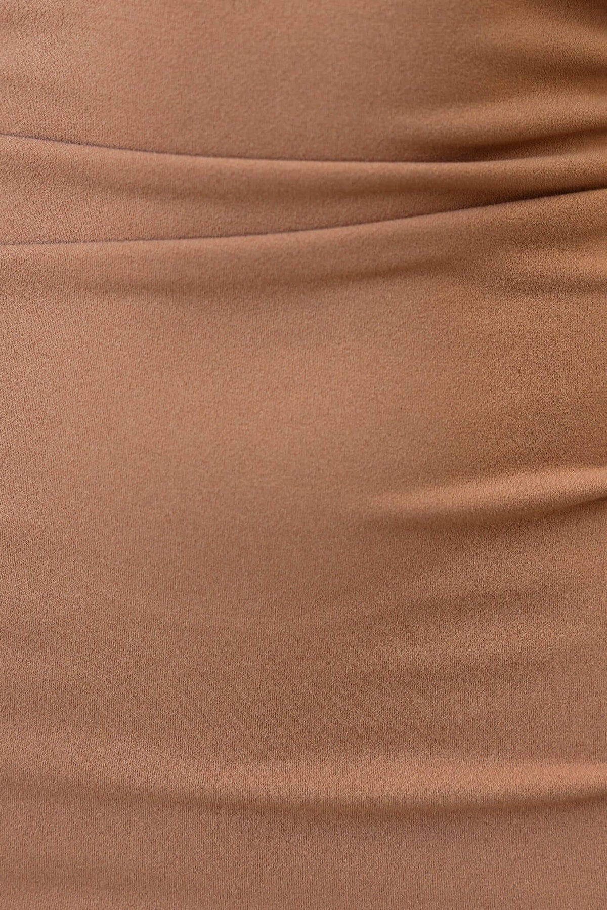 Close-up of the fabric of the Lillette Midi Dress, showcasing its smooth, stretchy texture in a warm, brown hue.