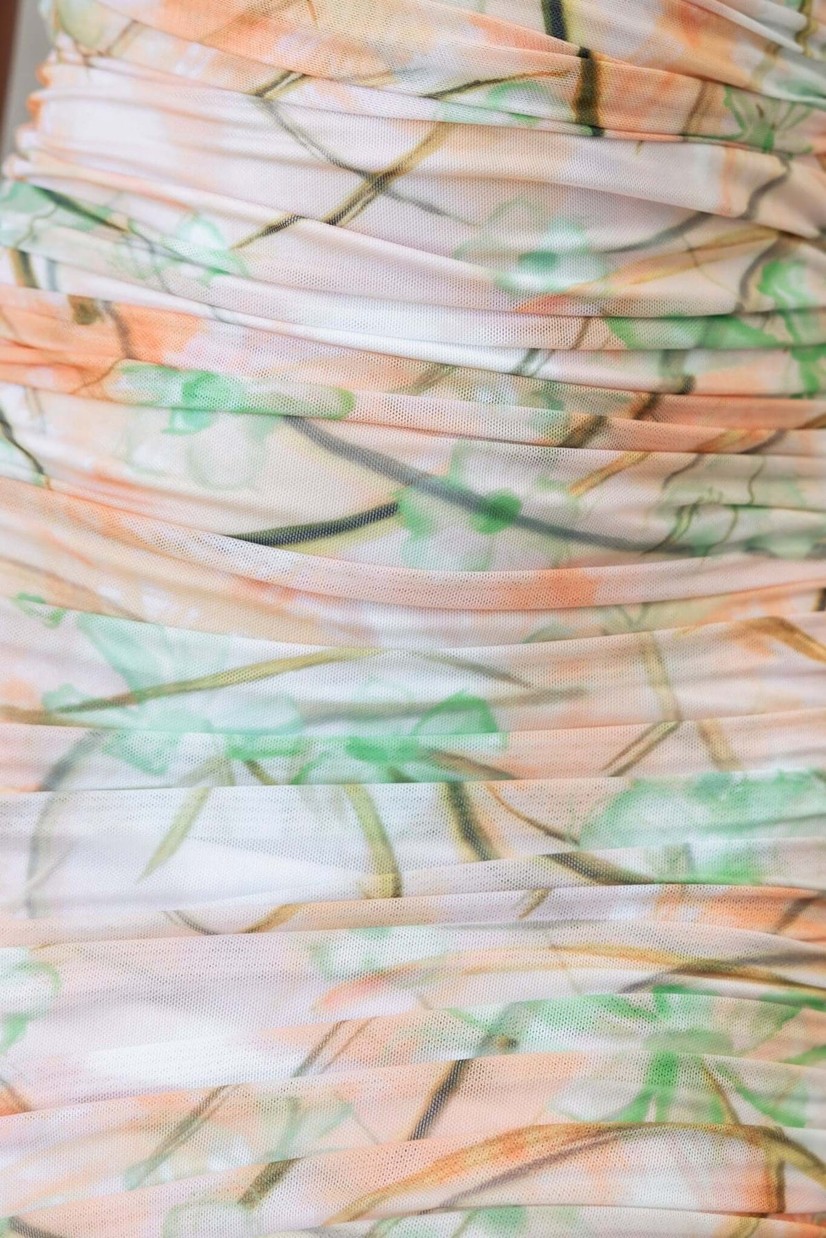 Close-up of Rarity Maxi Dress fabric featuring a floral pattern with ruching details in soft pastel colors.