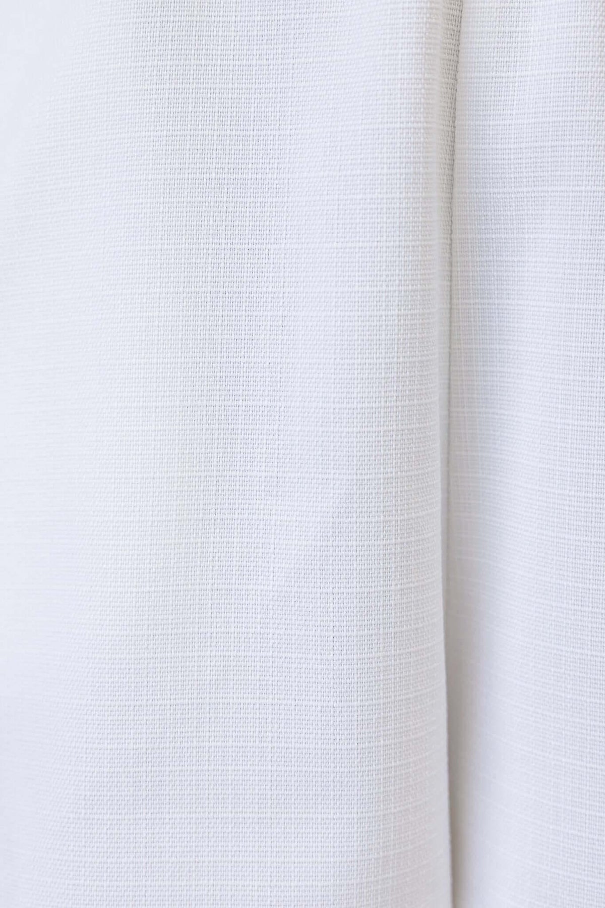 Close-up texture of a white fabric showcasing a subtle grid pattern, suitable for a timeless playsuit design.