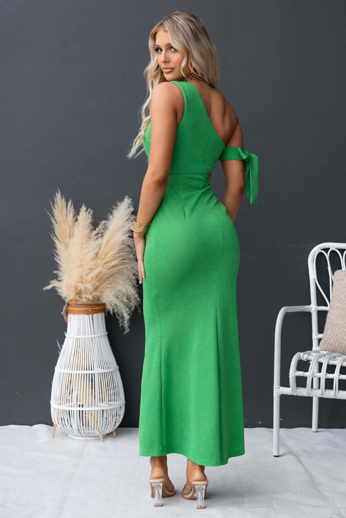 Green Malian maxi dress featuring a one-shoulder neckline and attached tie, styled with a chic back view.