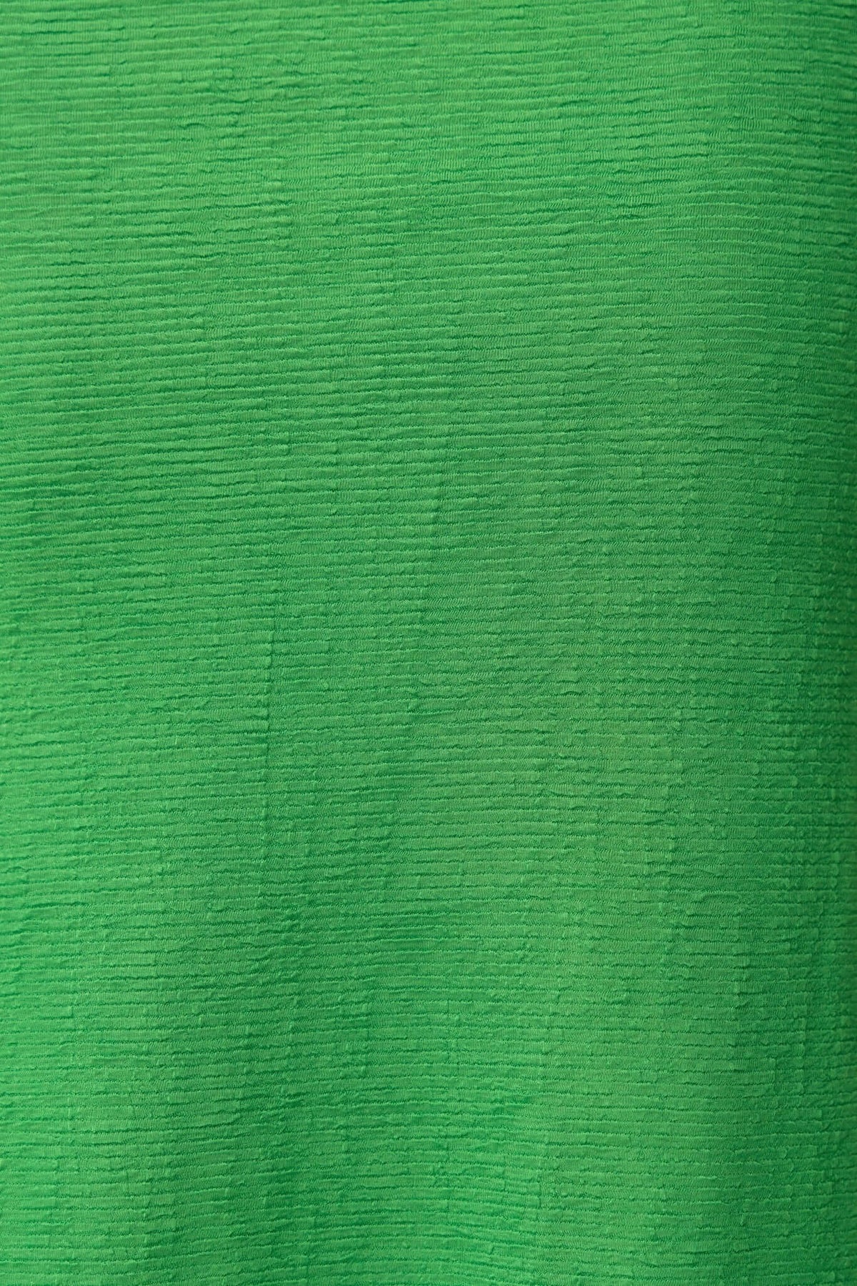 Close-up of textured green fabric used in the Malian Maxi Dress, showcasing its vibrant color and unique material.