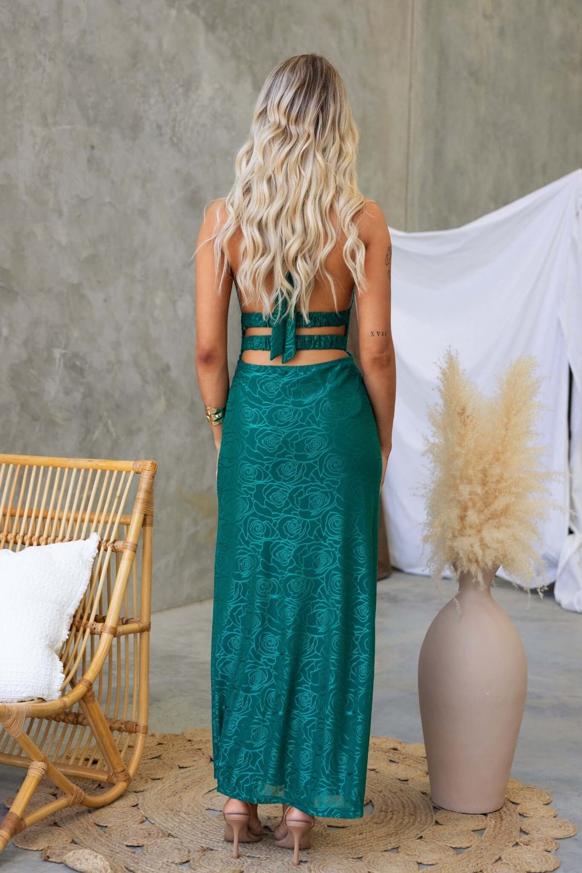 Back view of Piazia Maxi Dress featuring tie straps and a split, styled with a modern interior decor.