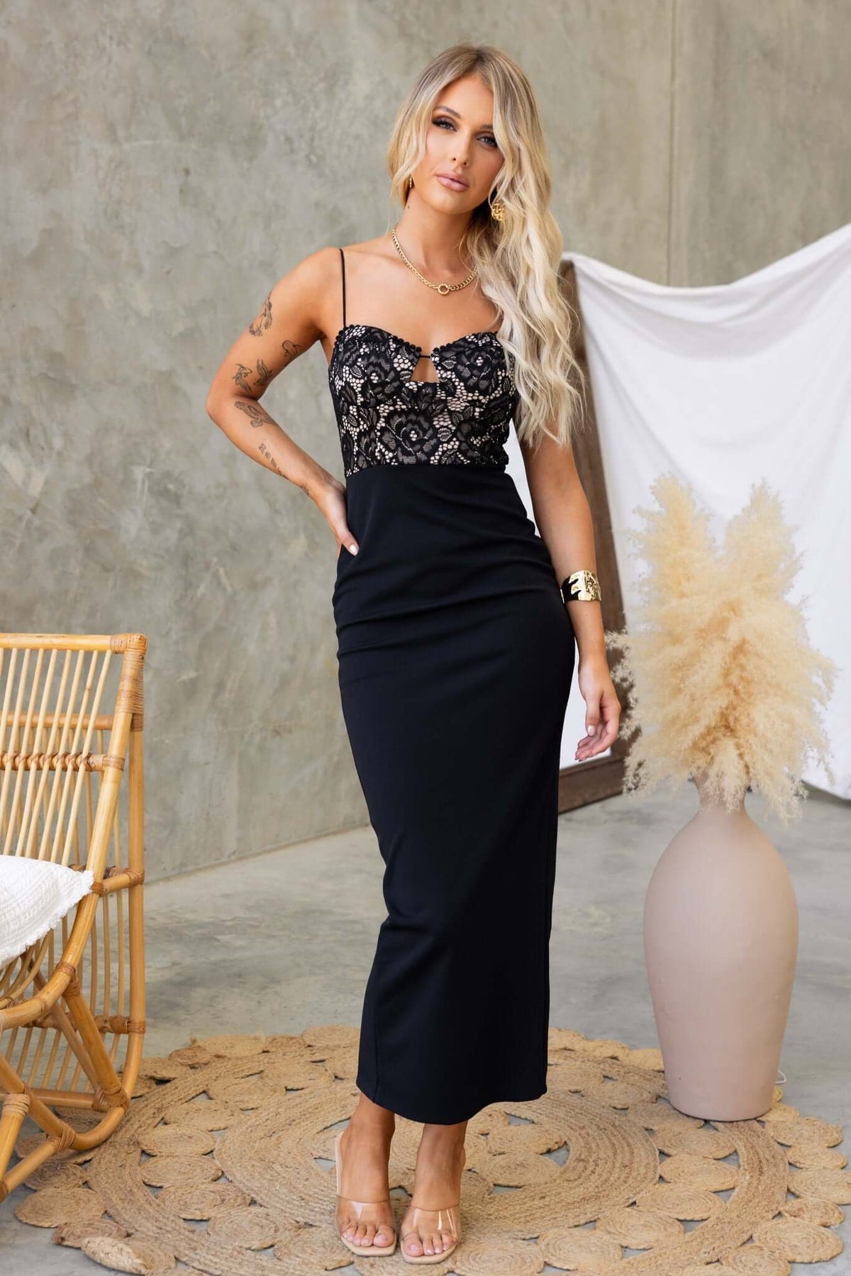 Elegant black Tempest Maxi Dress with adjustable straps, lace detailing, and a fitted silhouette.