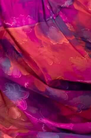 Textured floral fabric in vibrant pink and purple hues, perfect for a stylish maxi dress.