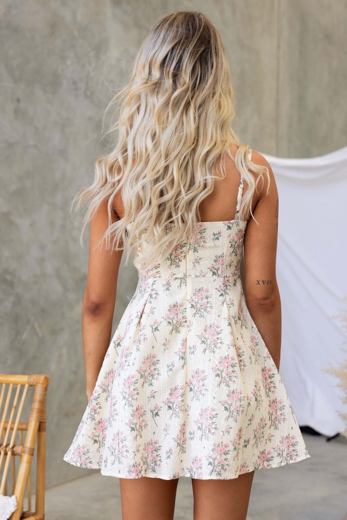 Back view of the Gazelle Dress featuring adjustable straps and floral design, perfect for warm weather occasions.