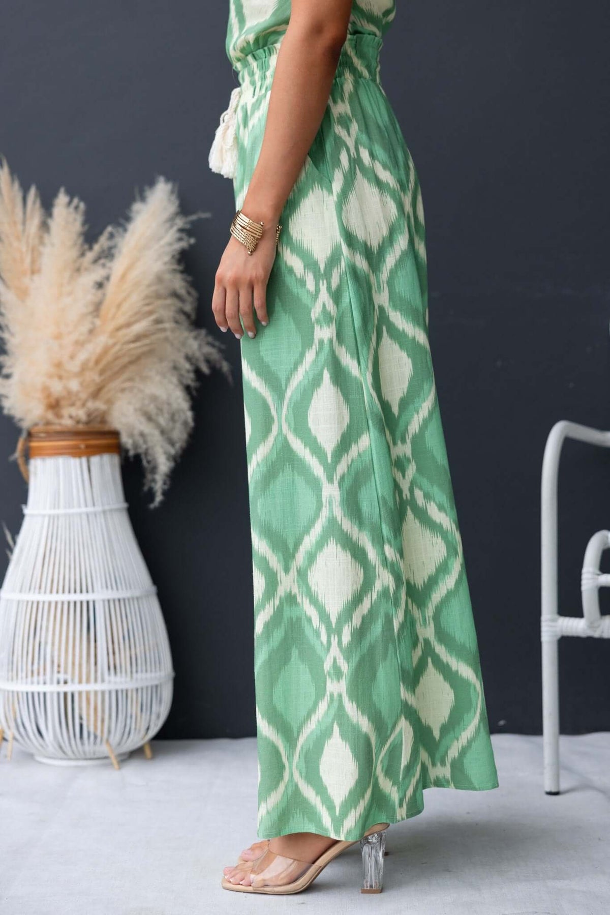 Model wearing green Mason Pants with a mid-high waist and drawstring, styled with boho accessories.