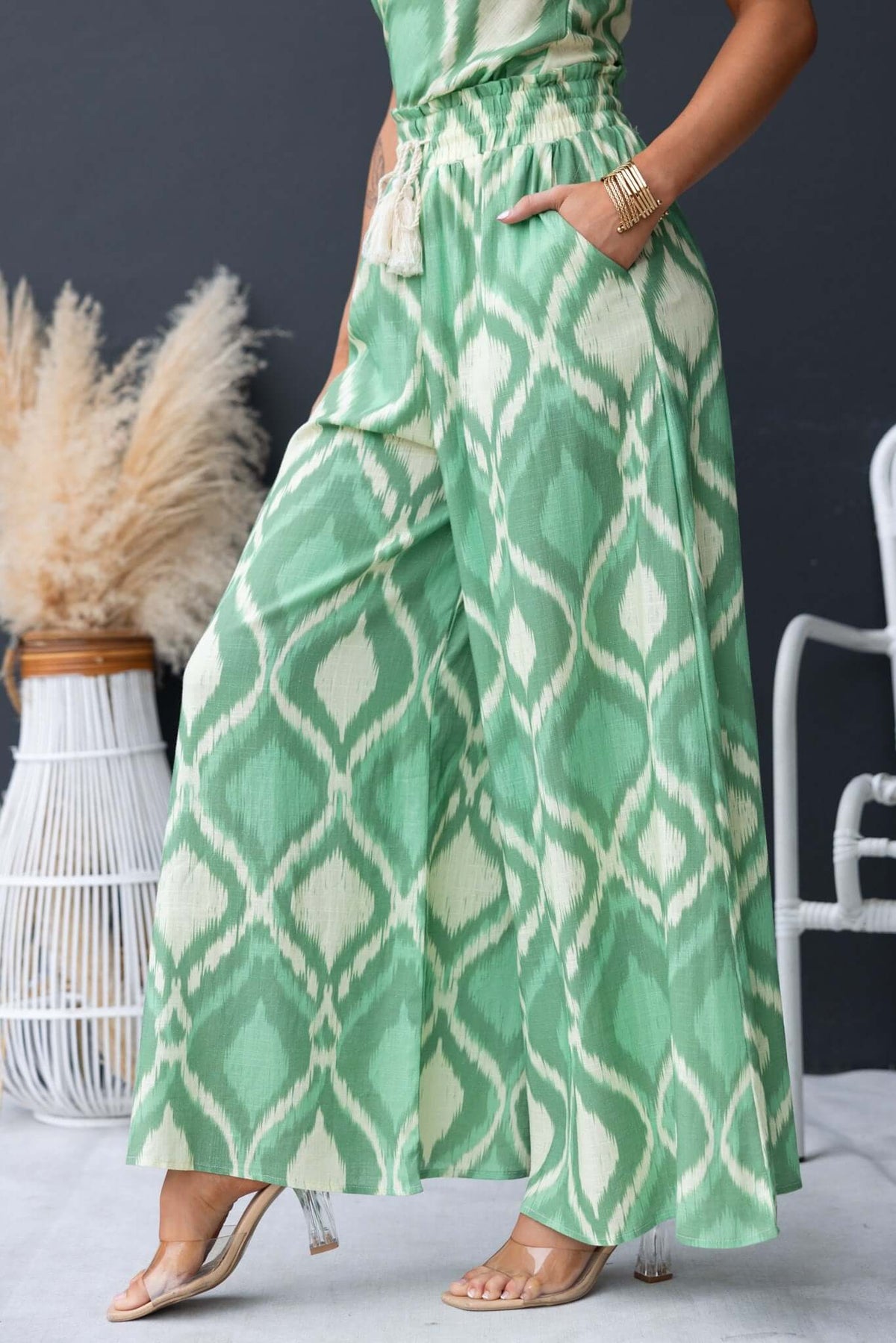 Mason Pants in green with geometric print, featuring a mid-high waist, elastic waistband, and pockets.