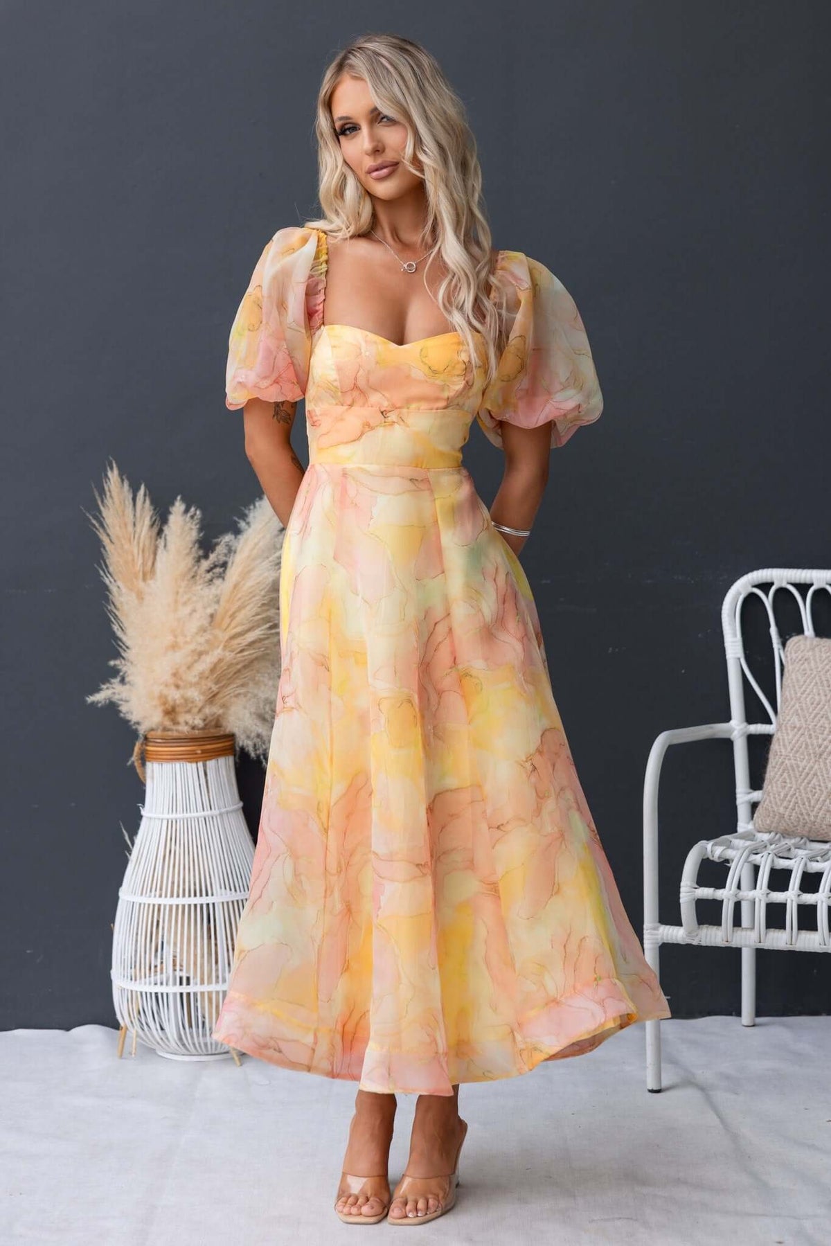 Nerine Maxi Dress in soft pastel colors, featuring puff sleeves and a flowy silhouette for a stylish summer look.