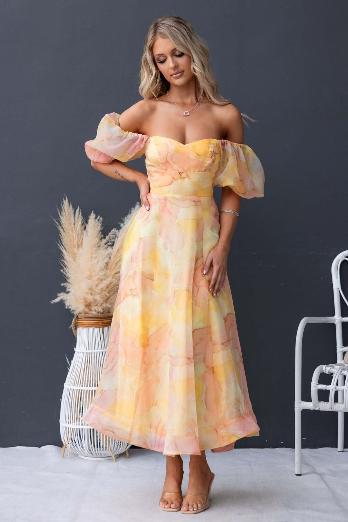 Model wearing a flowing Nerine Maxi Dress in pastel colors with puff sleeves, perfect for summer occasions.