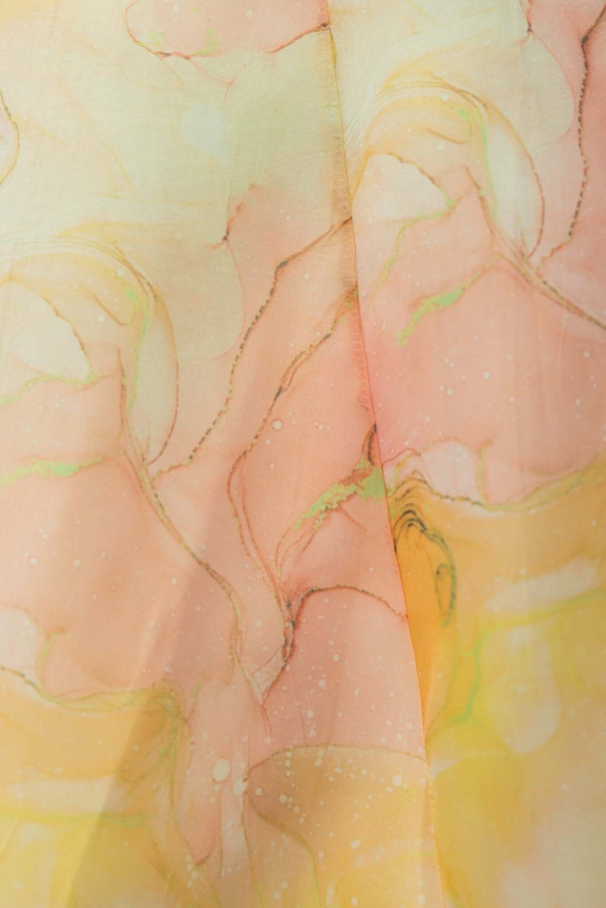 Close-up of flowing fabric with soft pastel colors and abstract patterns, perfect for a Nerine Maxi Dress.