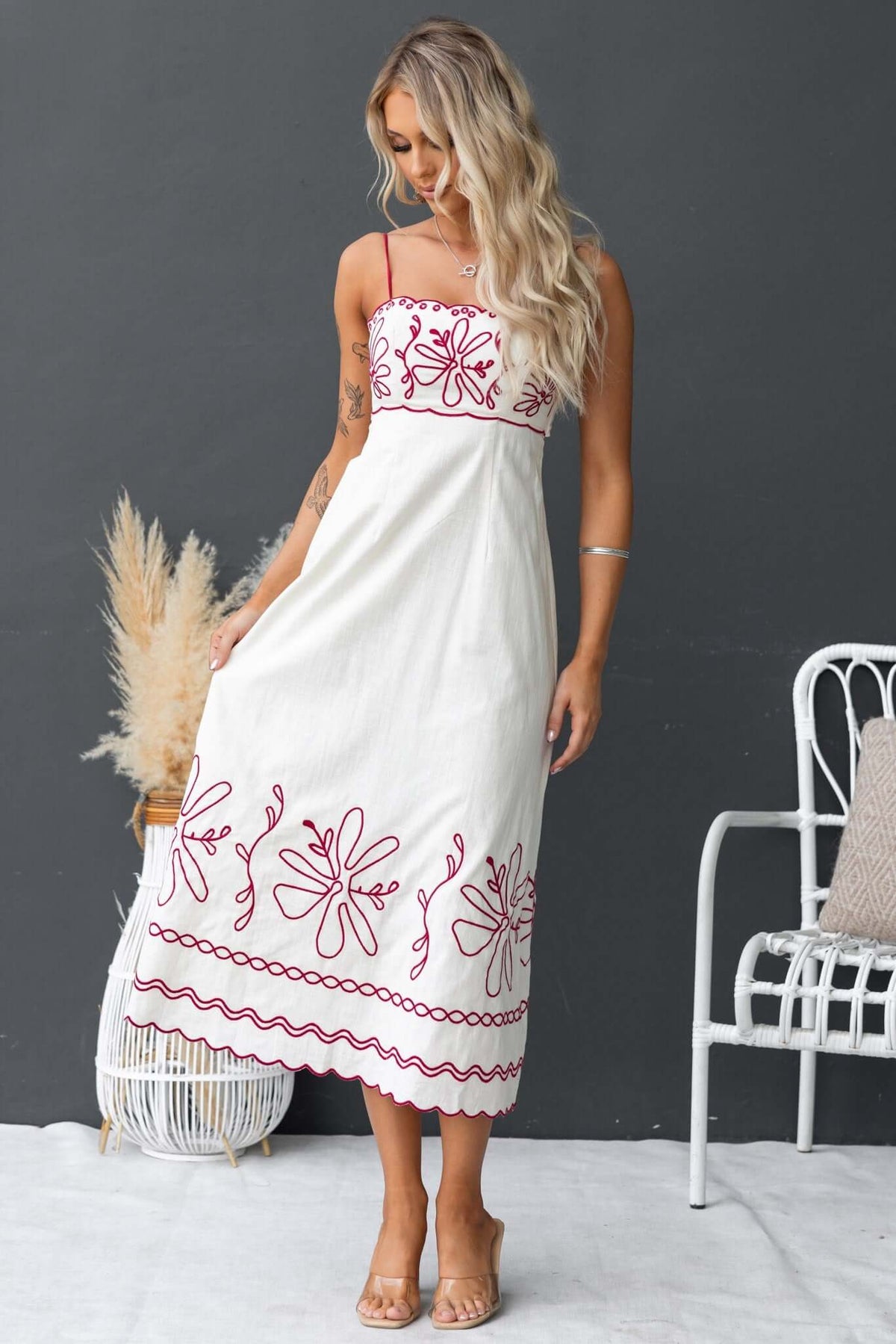 Model wearing the Homestead Midi Dress with floral embroidery and adjustable straps, perfect for casual summer outings.