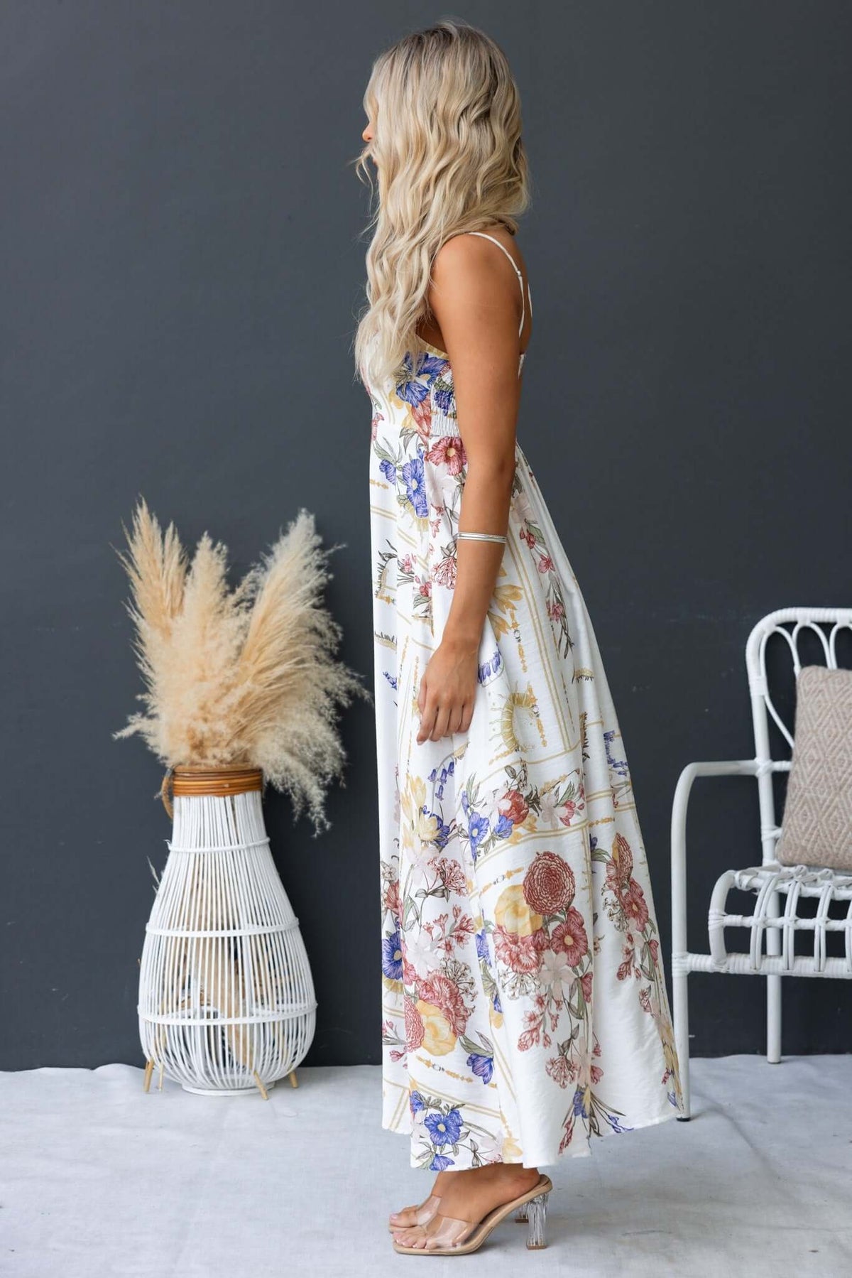 Model wearing the Salilah Maxi Dress with floral print, featuring adjustable straps and pockets.