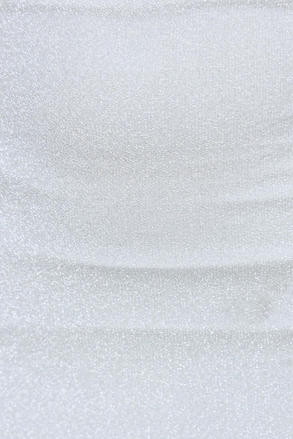 Close-up of metallic fabric in silver, showcasing shimmer and stretch, ideal for stylish tops like the Bemmie Top.