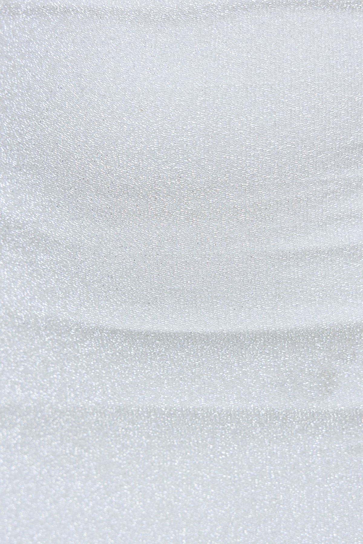 Close-up of metallic fabric showcasing its soft shimmer and smooth texture, ideal for a stylish skirt like the Bemmie Skirt.